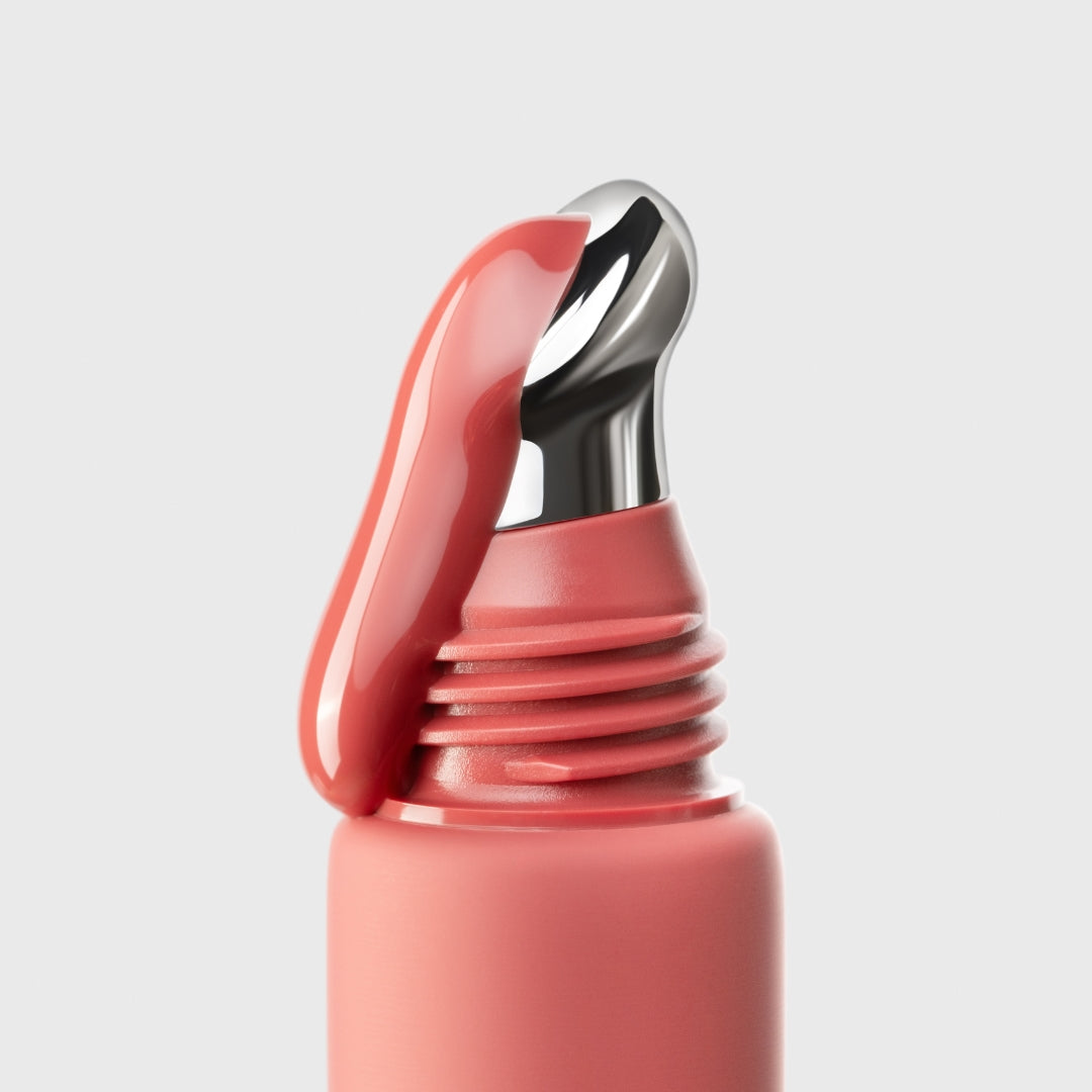 Close-up of berry crumble an-gloss with a silver cap on a light gray background