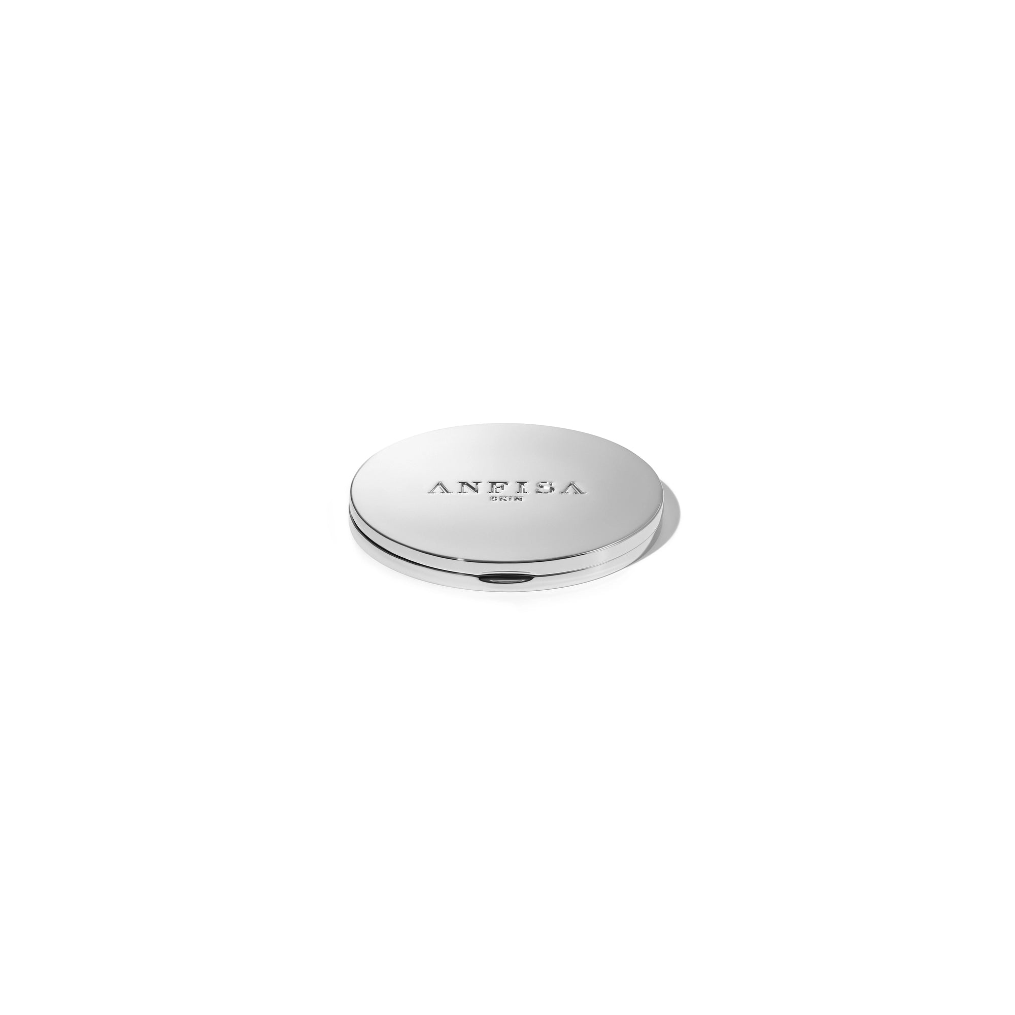 2.75 inches in diameter anfisa skin compacted mirror with debossed Anfisa Skin logo on main face in polished silver solid metal body.