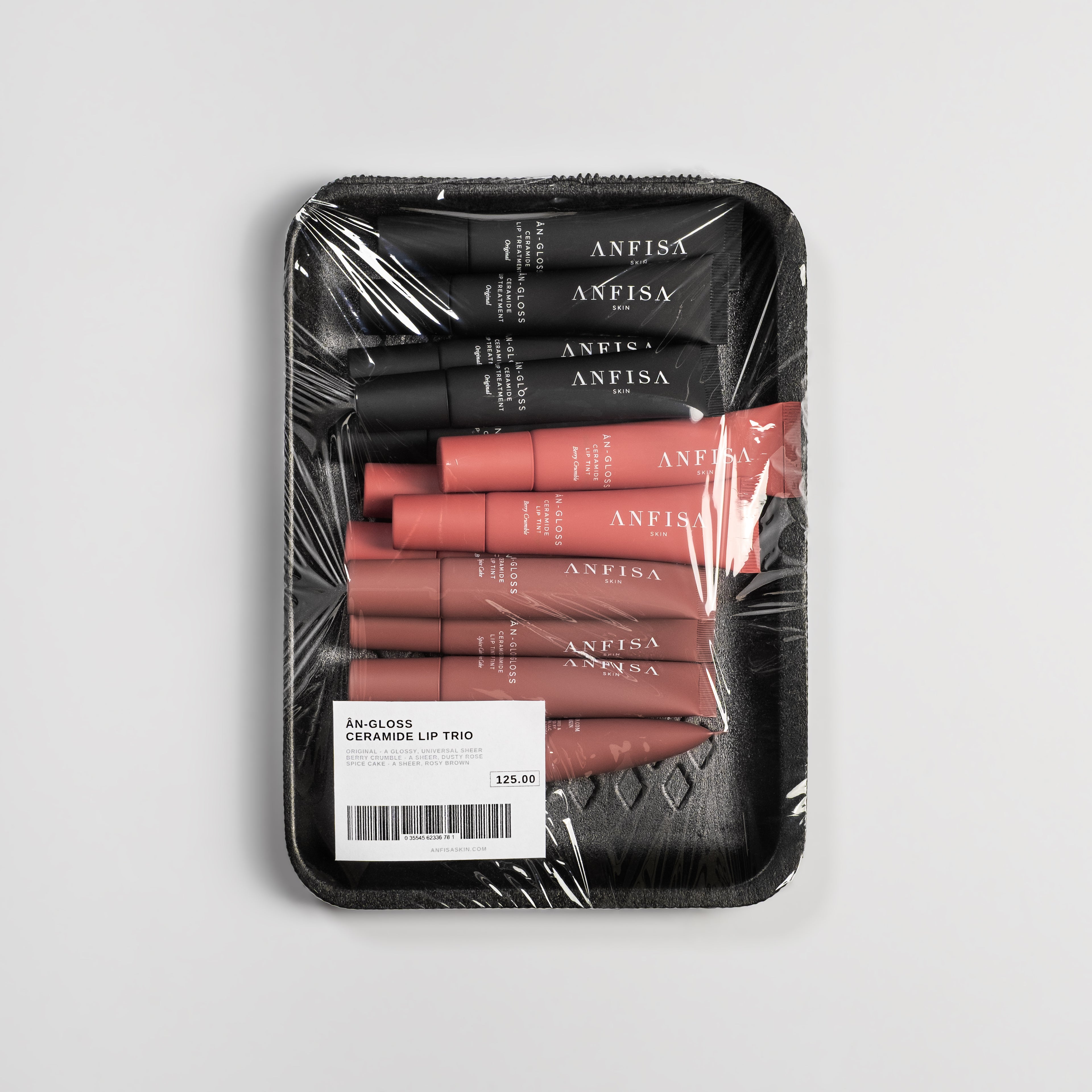 Packaged set of ANFISA lip products on a gray background
